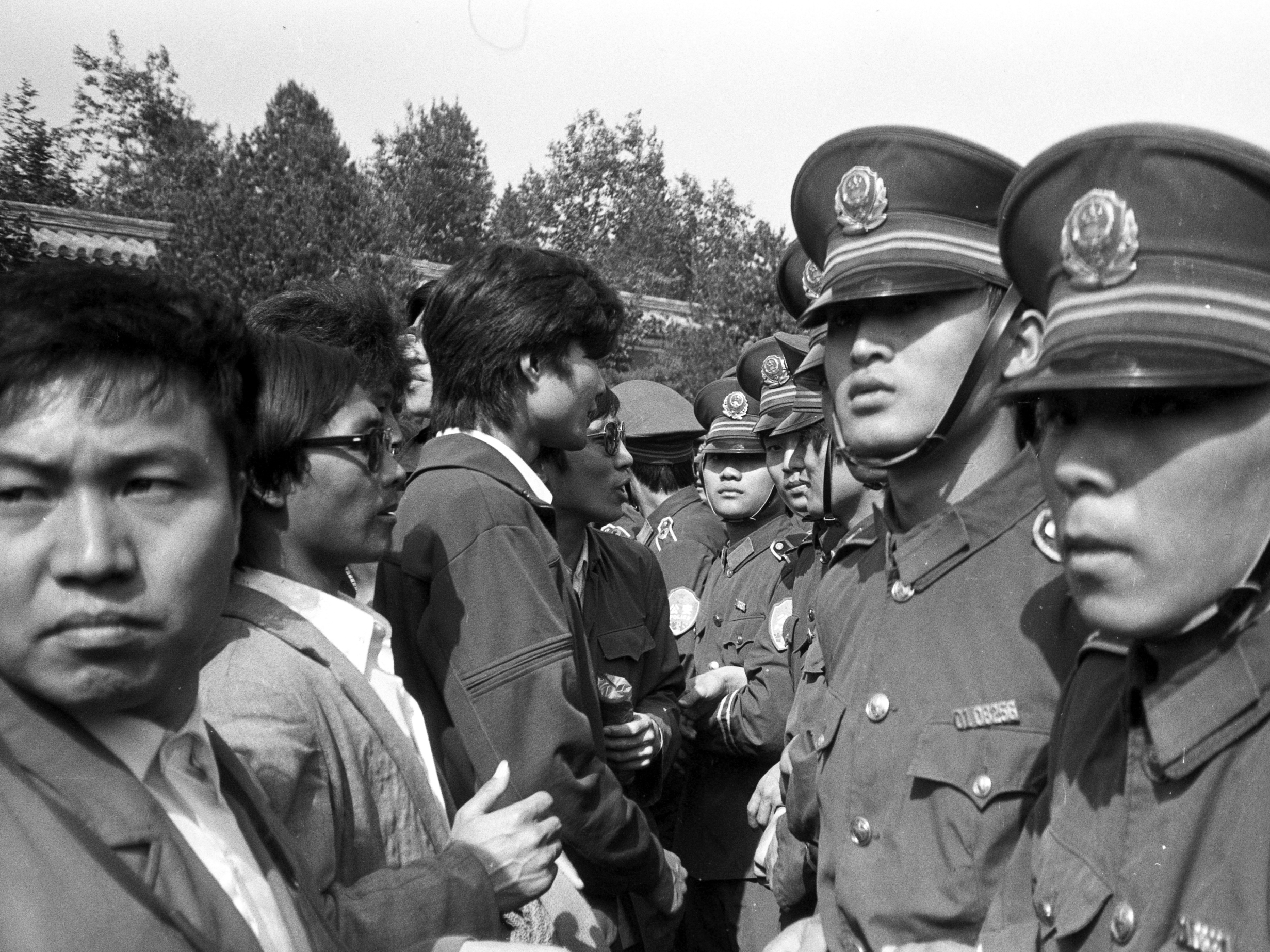 caption: Students stand face to face with police. Tens of thousands of students from across the country, as well as professors, blue-collar workers and passersby, joined the protests.