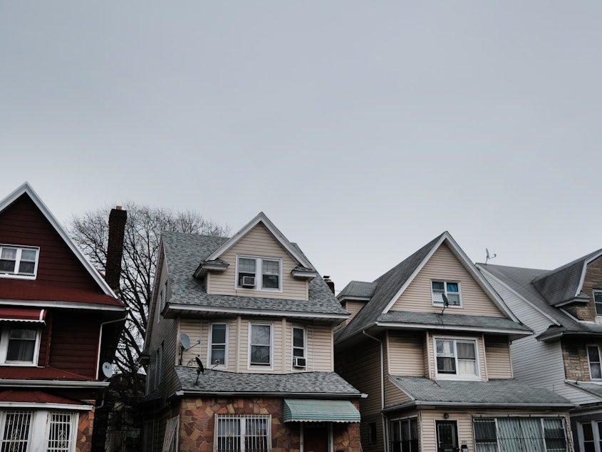 caption: Homes line the street of a Brooklyn neighborhood in March in New York City. Zillow announced it will stop buying and reselling homes, citing the volatility of the housing market.