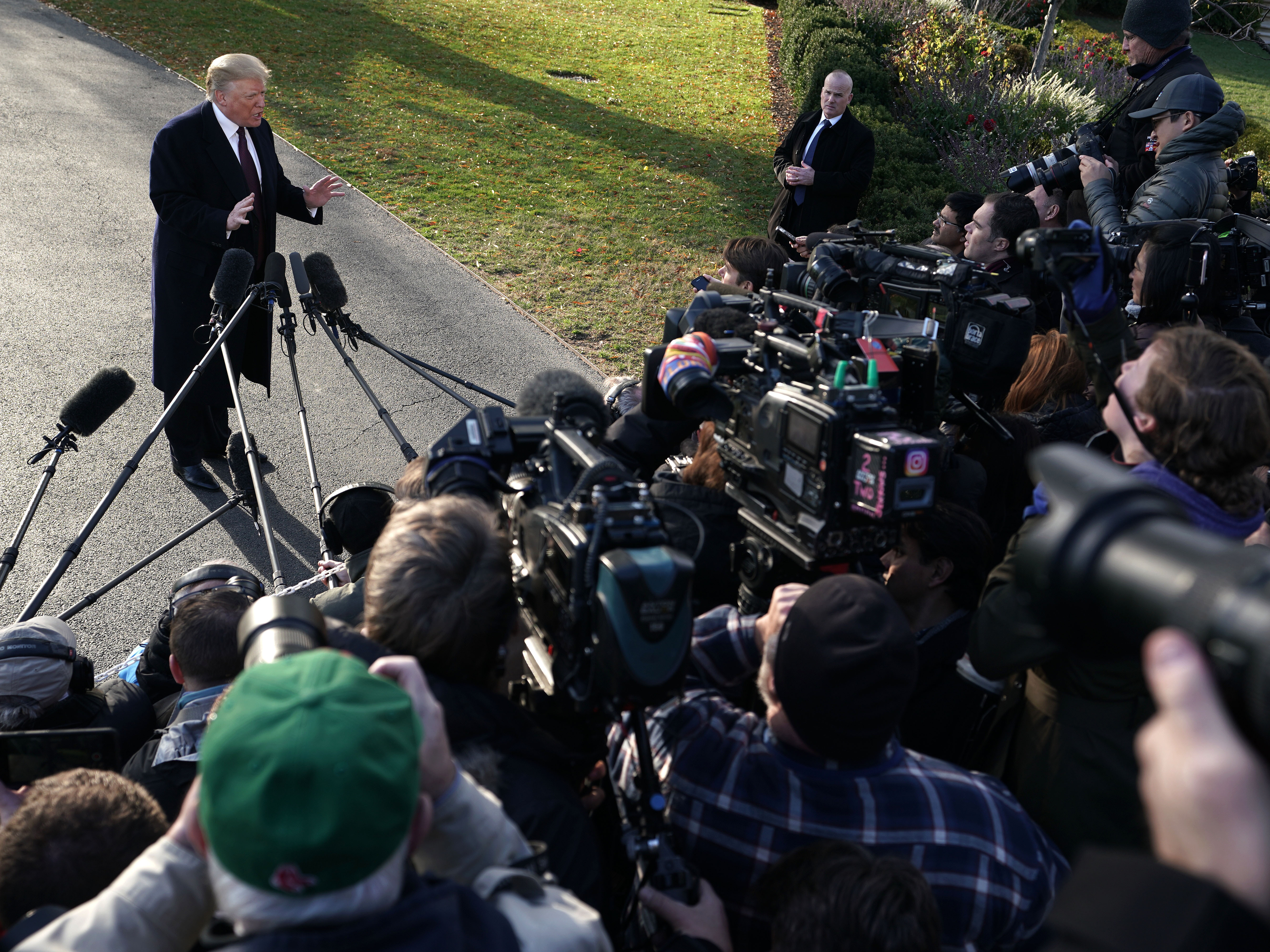 caption: Donald Trump speaks to members of the media in November 2018.