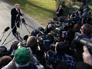 caption: Donald Trump speaks to members of the media in November 2018.