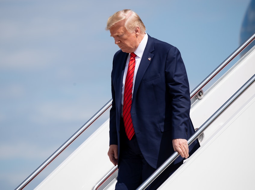 caption: President Trump arrives at Joint Base Andrews in Maryland on Thursday aboard Air Force One.