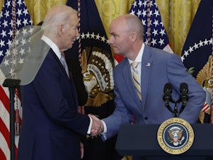 caption: President Biden shakes hands with Utah Gov. Spencer Cox during a meeting with governors from across the country at the White House on Feb. 23.
