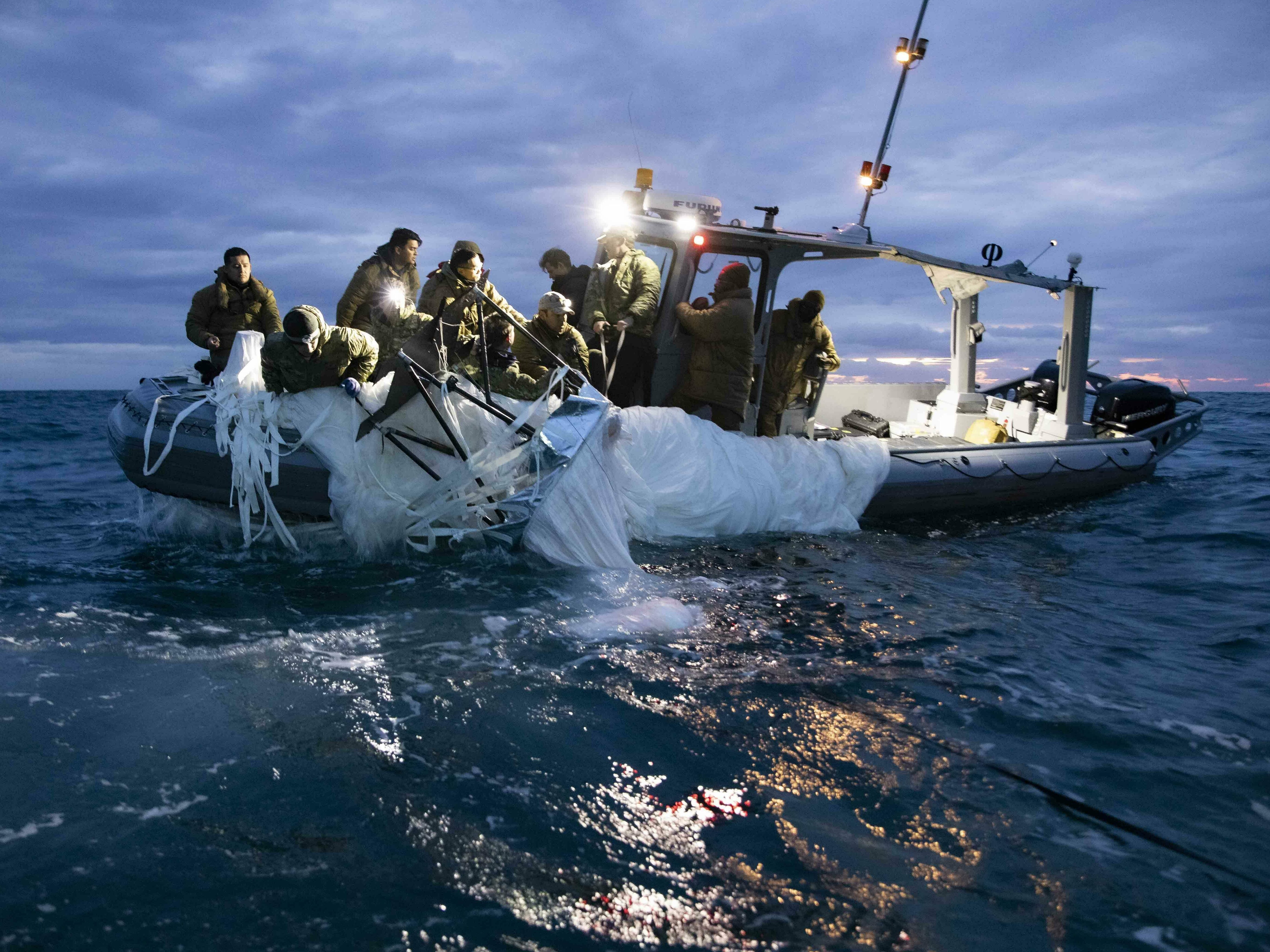 caption: Sailors recover a high-altitude surveillance balloon in the waters off the coast of Myrtle Beach, S.C., on Feb. 5, after a fighter jet shot the balloon out of the sky.
