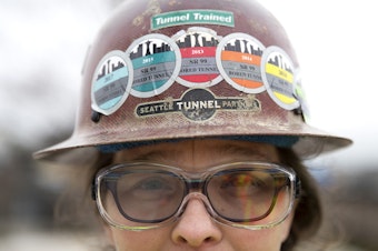 caption: Safety representative for the Seattle Tunnel Partners, Marisa Roddick, wears stickers on her helmet for each year that she has worked on the tunnel project, from 2013 to 2018, on Tuesday, March 27, 2018, in Seattle.