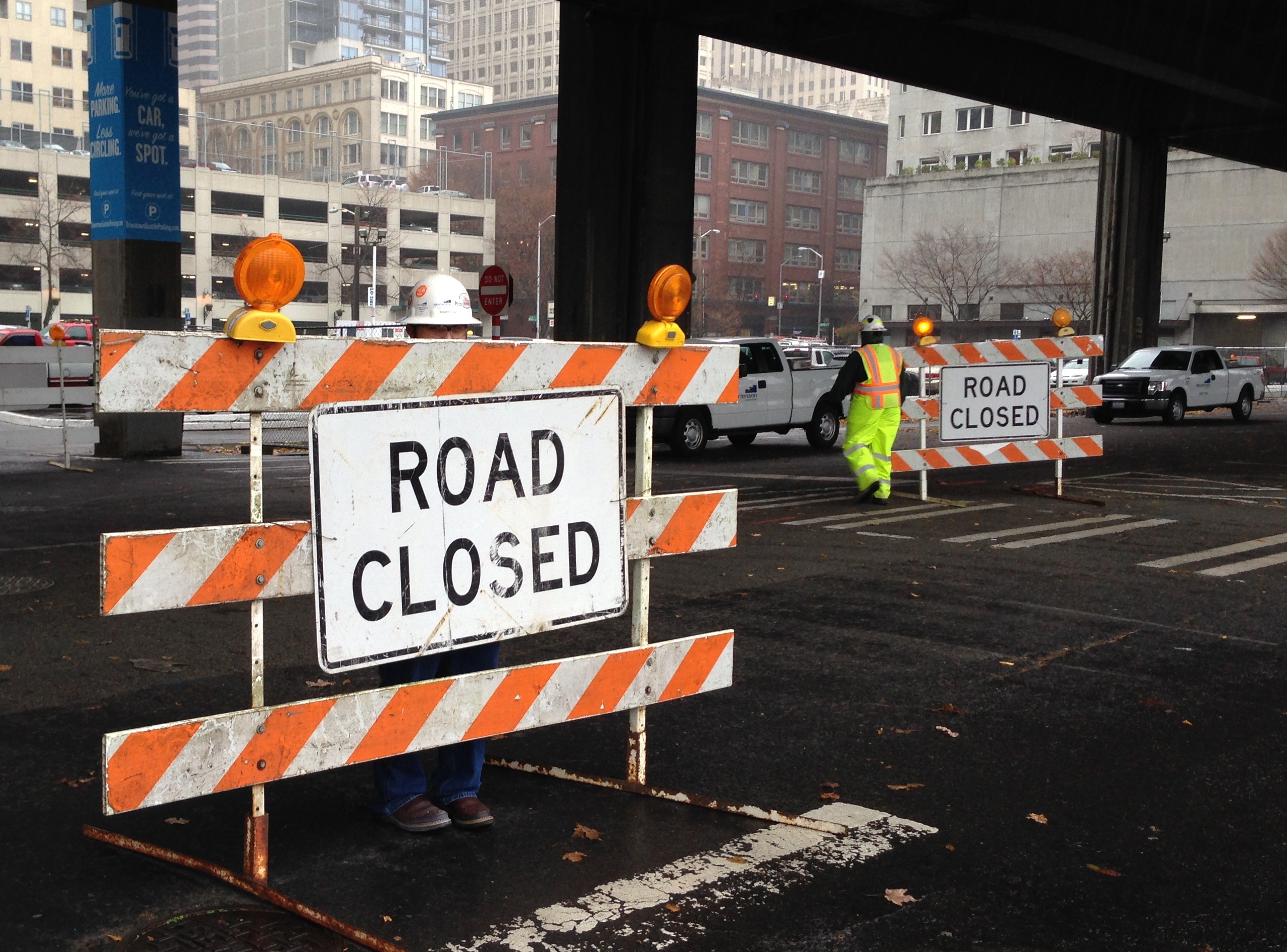 caption: Workers close off parking areas beneath the Alaskan Way Viaduct in downtown Seattle in preparation for seawall construction