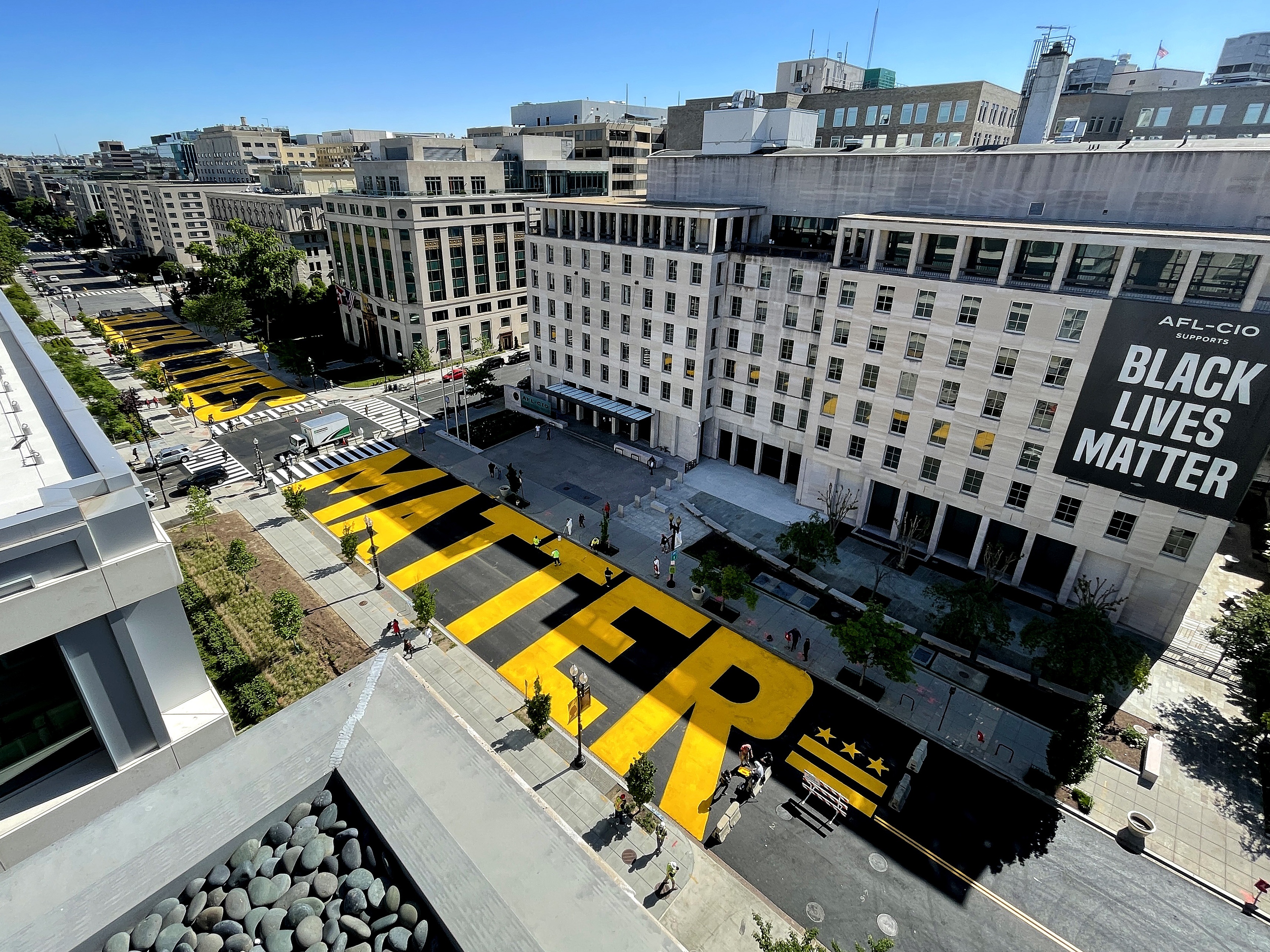 caption: Black Lives Matter Plaza on 16th Street Washington, D.C., is repainted following the removal of the lettering for a construction project on May 13, 2021.