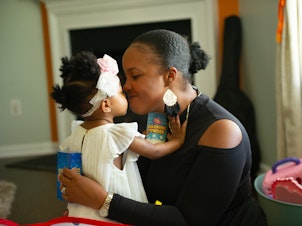 caption: Brittany Smith and her daughter at their home. The family has flourished in Charlotte. Two years ago, Smith and her husband bought a custom-built house and both found new work opportunities.