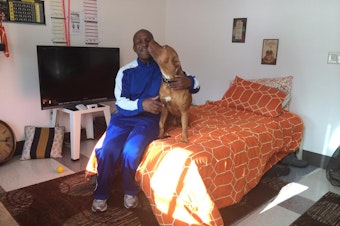caption: David Allen and his dog Blade - 'the love of his life' - live at the Pat Williams Apartments, a subsidized housing complex.