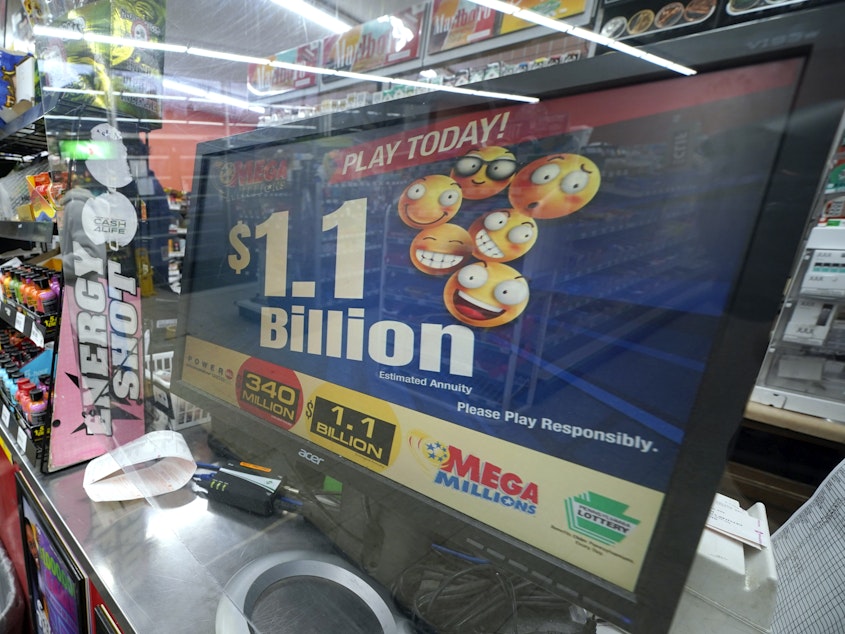 caption: A Mega Millions customer purchases her tickets for the estimated jackpot of $1.1 Billion at the Fuel On Convenience Store in Pittsburgh, Monday, Jan. 9, 2023. Twenty-four consecutive drawings later with no grand prize winner named, the Mega Millions jackpot is now over $1 billion, making it one of the largest jackpots in lottery history. The next drawing is Friday.