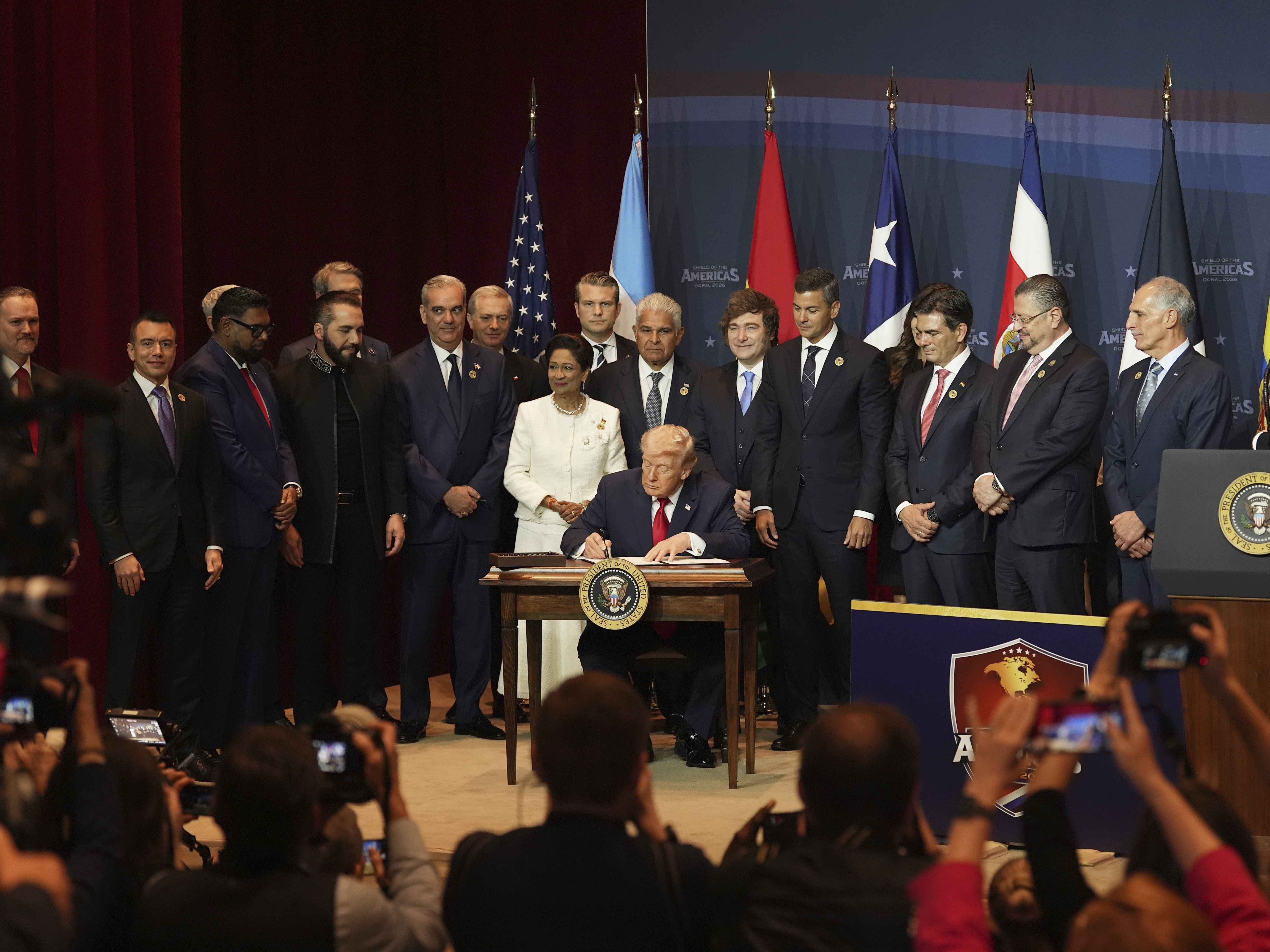 caption: President Trump signs a proclamation committing to countering cartel criminal activity at the Shield of the Americas Summit.