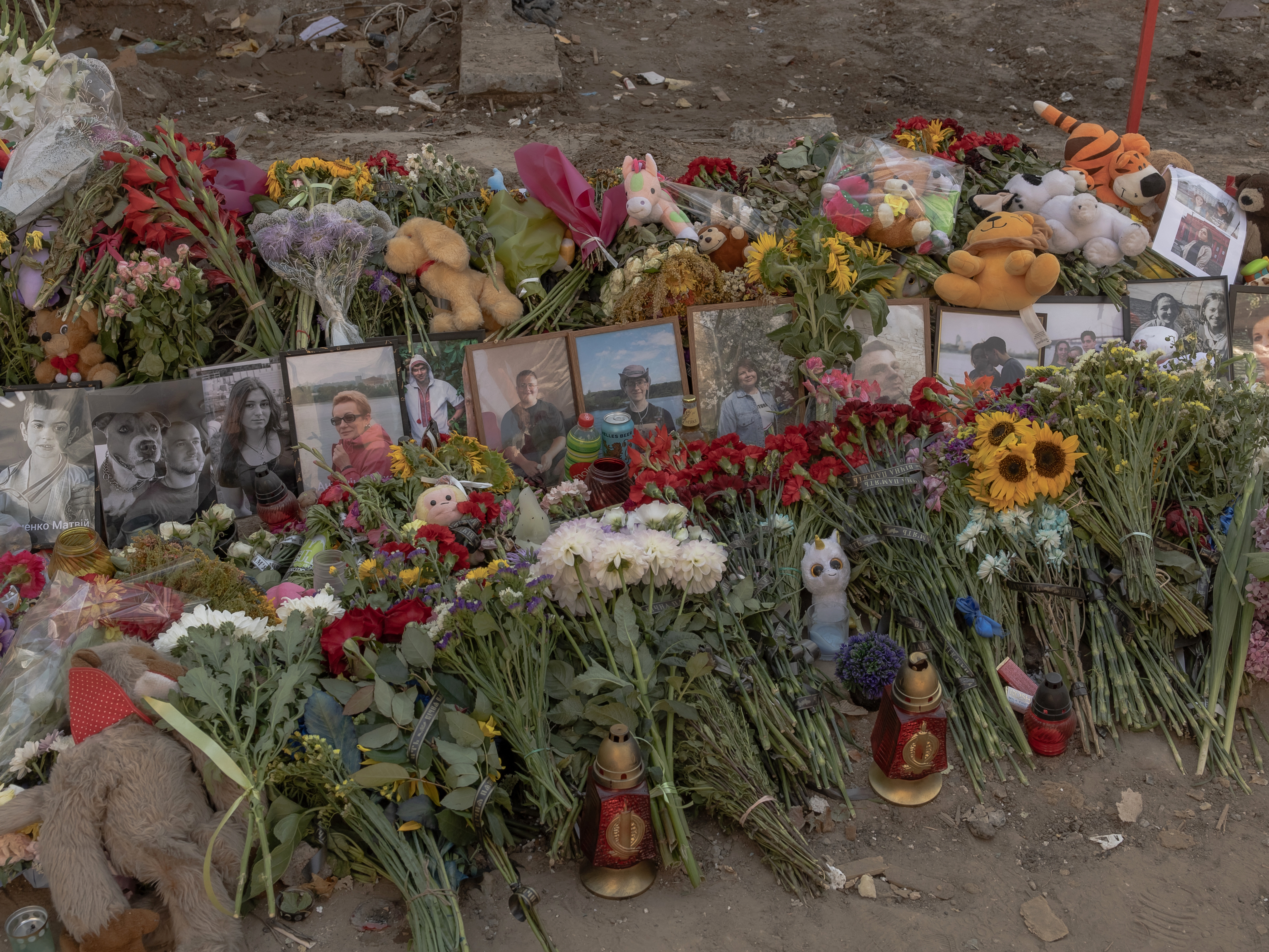 caption: Ukrainians have made a makeshift memorial outside an apartment building in the capital Kyiv that was hit by a Russian airstrike on July 31. A combined missile and drone attack killed more than 30 civilians and wounded more than 150 in the city that day.