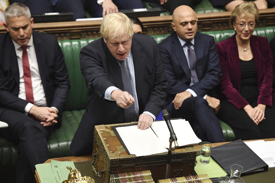 caption: Britain's Prime Minister Boris Johnson speaks to lawmakers inside the House of Commons to update details of his new Brexit deal with EU, in London Saturday Oct. 19, 2019. (Jessica Taylor/House of Commons via AP)