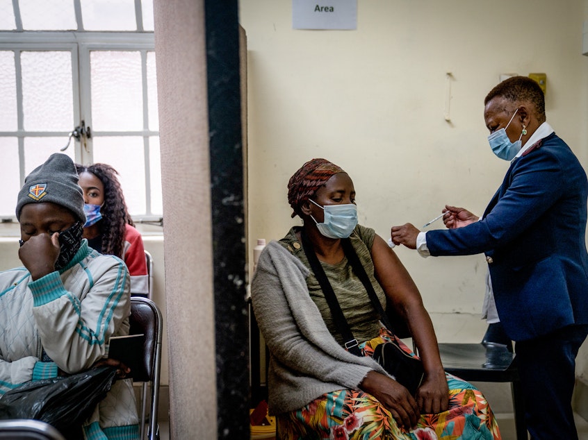 caption: A woman is vaccinated against COVID-19 at a clinic in Johannesburg on Dec. 6. A new study from South Africa looks at the effectiveness of the Pfizer vaccine in preventing infection and severe disease.