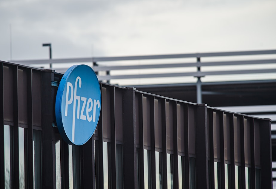 caption: Pfizer's logo is shown on the company's production plant in Puurs, Belgium, on Dec. 23, 2020.