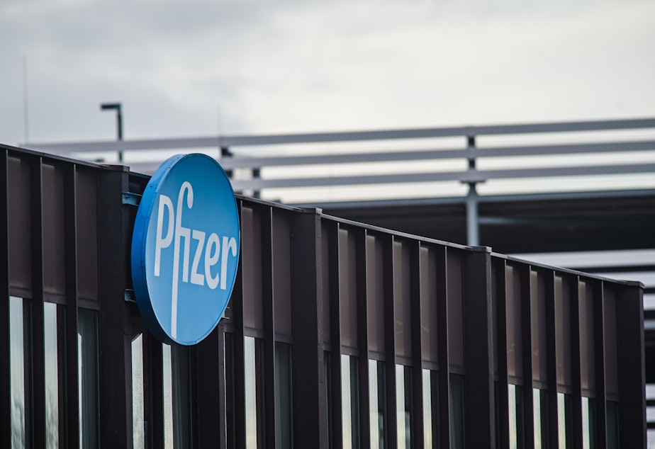 caption: Pfizer's logo is shown on the company's production plant in Puurs, Belgium, on Dec. 23, 2020.
