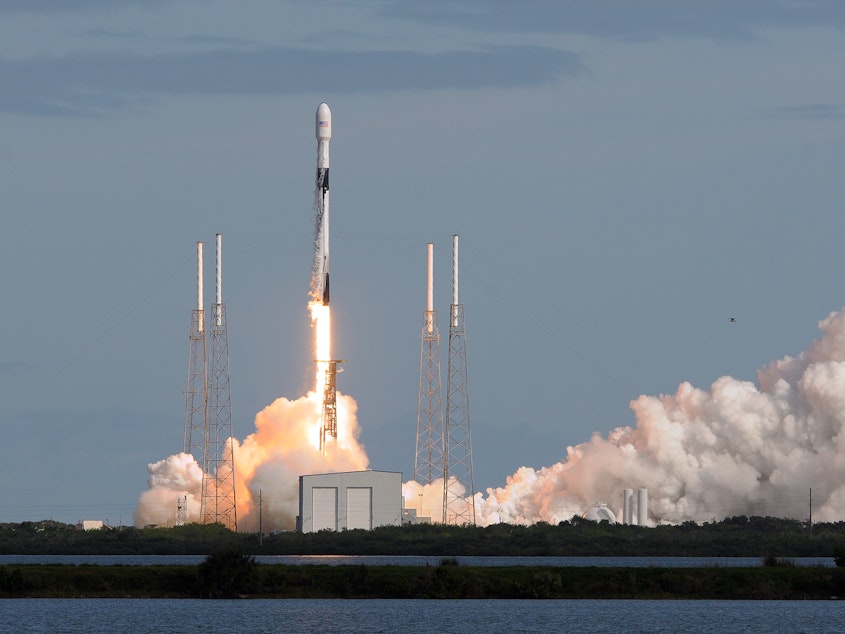caption: A SpaceX Falcon 9 rocket lifts off Monday from Florida's Cape Canaveral Air Force Station carrying 60 Starlink satellites. The Starlink constellation eventually will consist of thousands of satellites designed to provide worldwide high-speed Internet service.