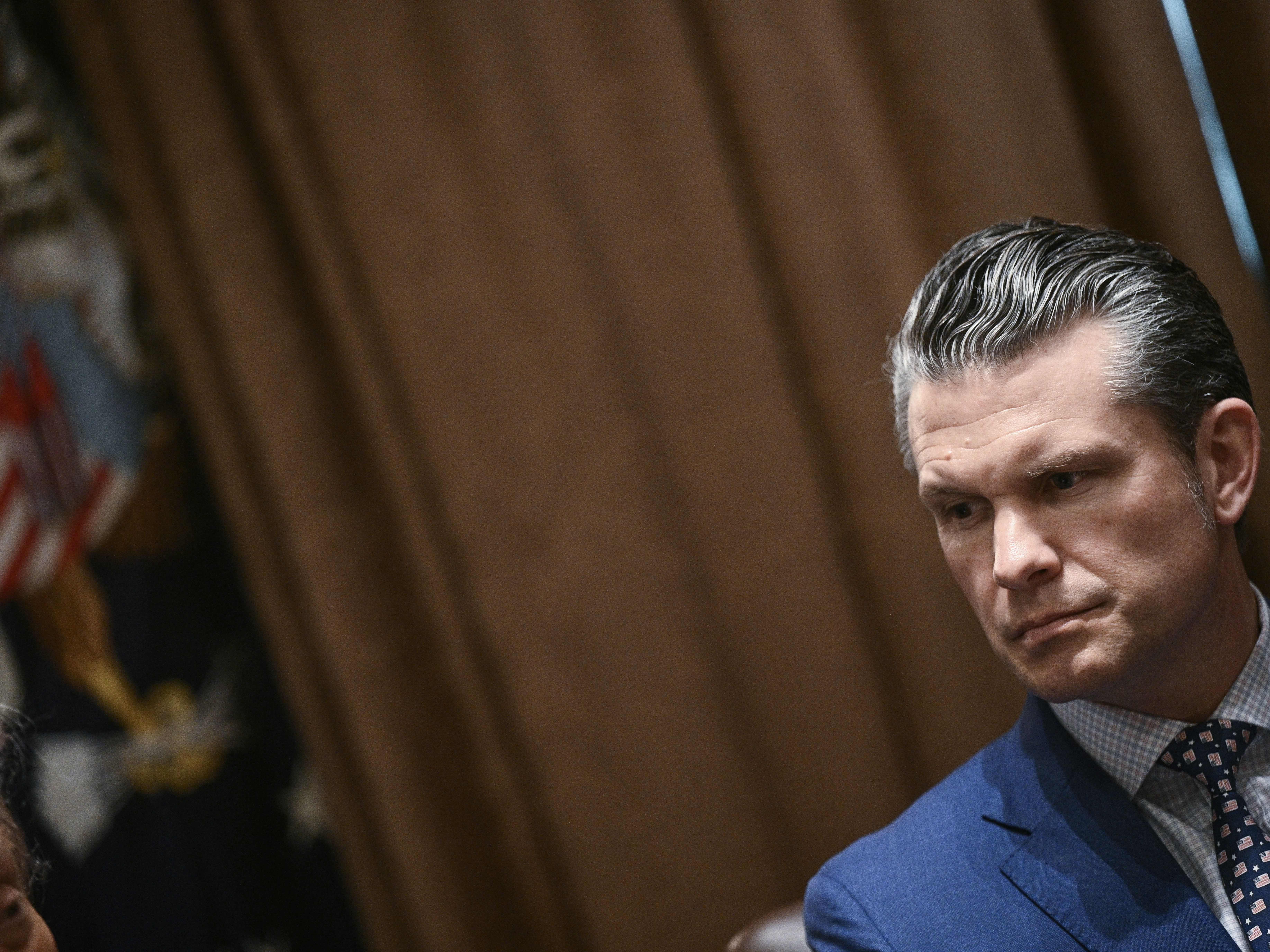 caption: Secretary of Defense Pete Hegseth looks on during a cabinet meeting with President Trump in the Cabinet Room of the White House on April 10.