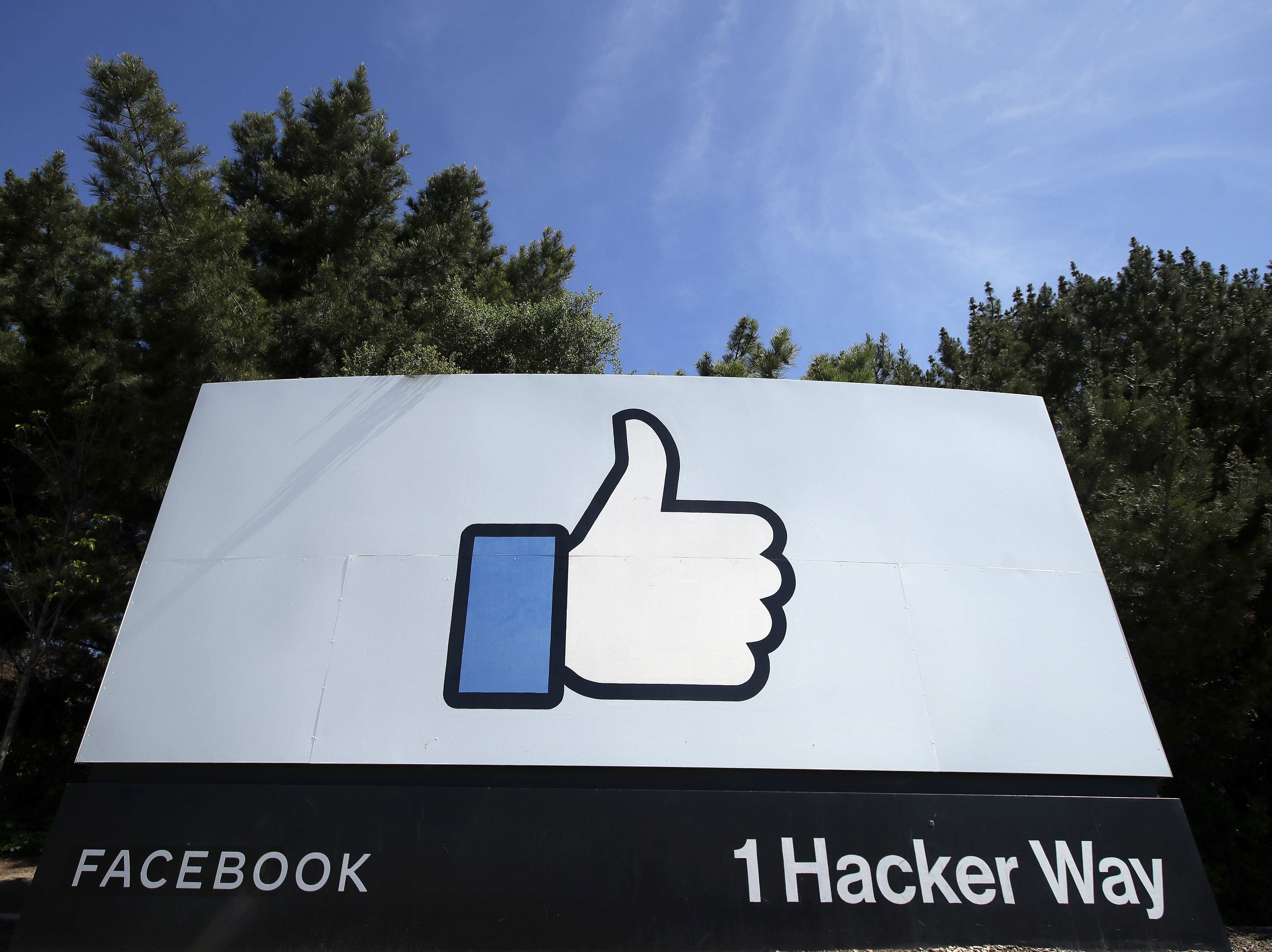 caption: In this April 14, 2020 file photo, the thumbs up "like" logo is shown on a sign at Facebook headquarters in Menlo Park, Calif. Facebook says it plans to hire 10,000 workers in the European Union over the next five years to work on a new computing platform.