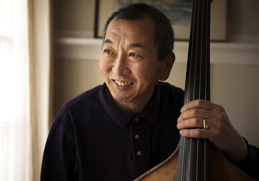 caption: Marcus Tsutakawa, former orchestra director at Seattle's Garfield High School, poses for a portrait with his double bass on Tuesday, November 28, 2017, at his home in Seattle. Marcus is the youngest of George and Ayame Tsutakawa's four children.