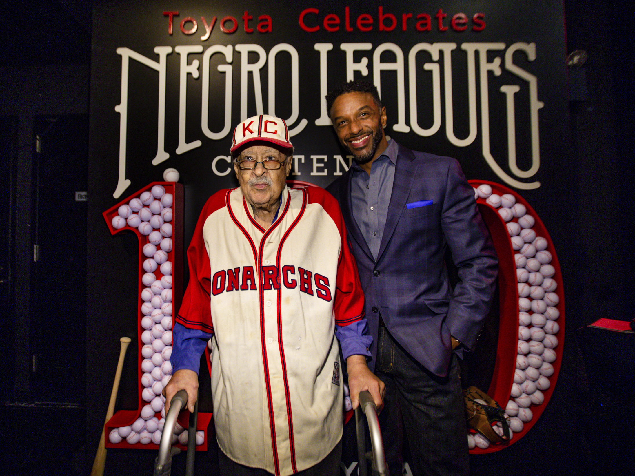 caption: Negro Leagues baseball veteran Jim Robinson and ESPN/ABC correspondent Ryan Smith attend an event celebrating 100th anniversary of the league in New York in February.