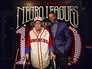 caption: Negro Leagues baseball veteran Jim Robinson and ESPN/ABC correspondent Ryan Smith attend an event celebrating 100th anniversary of the league in New York in February.
