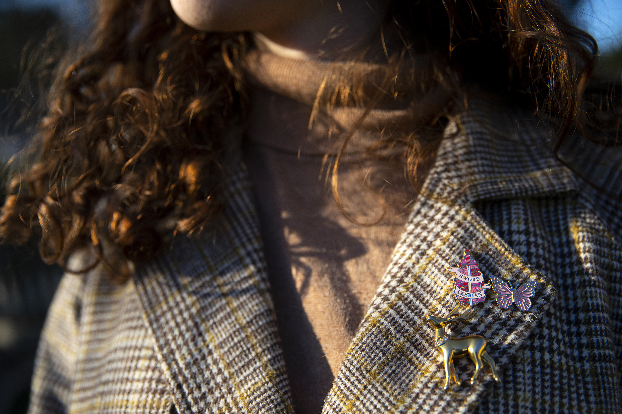 caption: Rebecca is portrayed wearing pins outside of her home on Thursday, February 19, 2026, in Tacoma. 