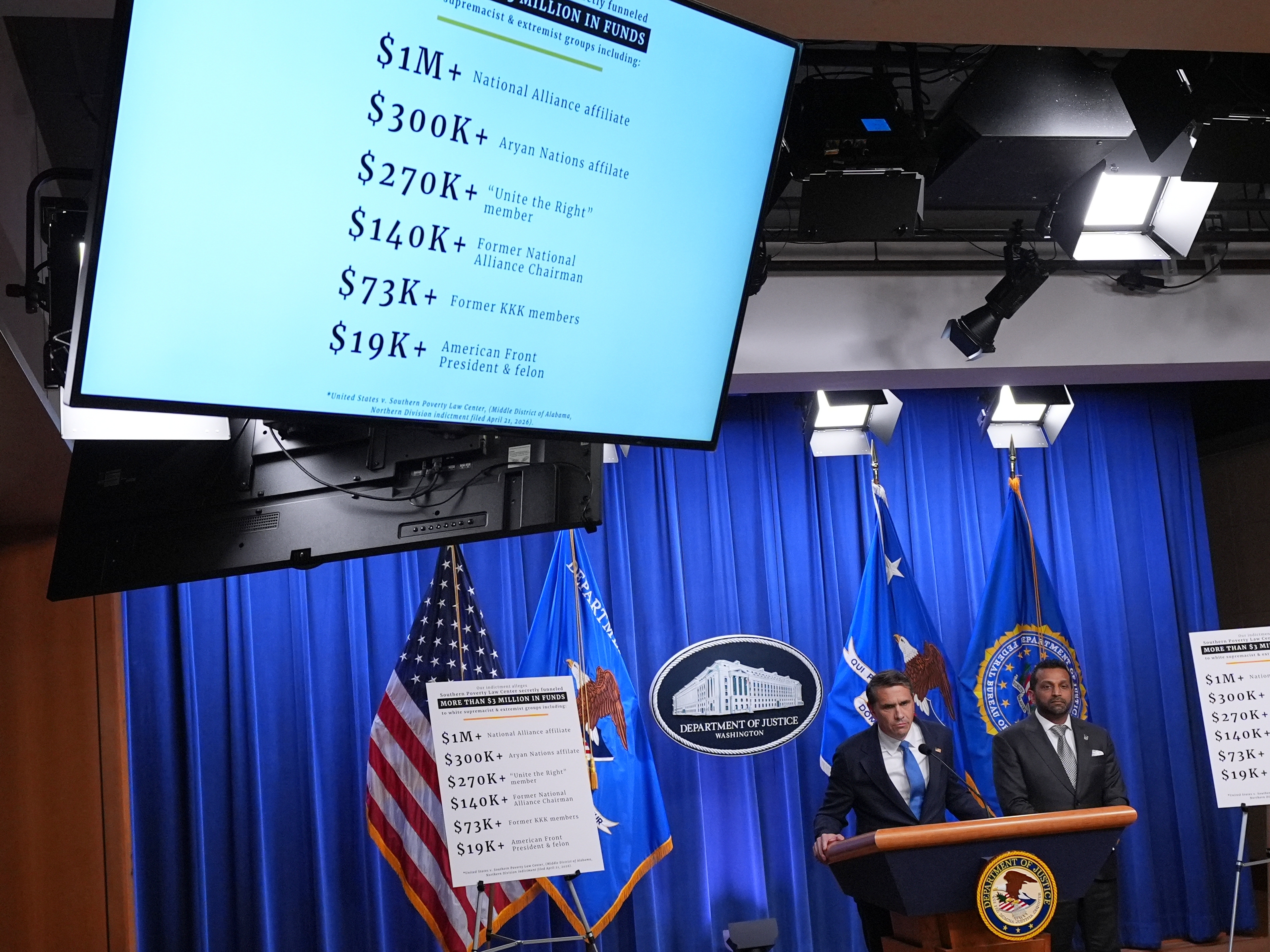 caption: Acting Attorney General Todd Blanche speaks as FBI Director Kash Patel listens during a news conference at the Justice Department on Tuesday in Washington.