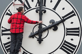 caption: This picture taken in March 2018 shows a technician working on the clock of the Lukaskirche Church in Dresden, eastern Germany. This weekend, Americans will wind back this clocks as daylight saving time ends.