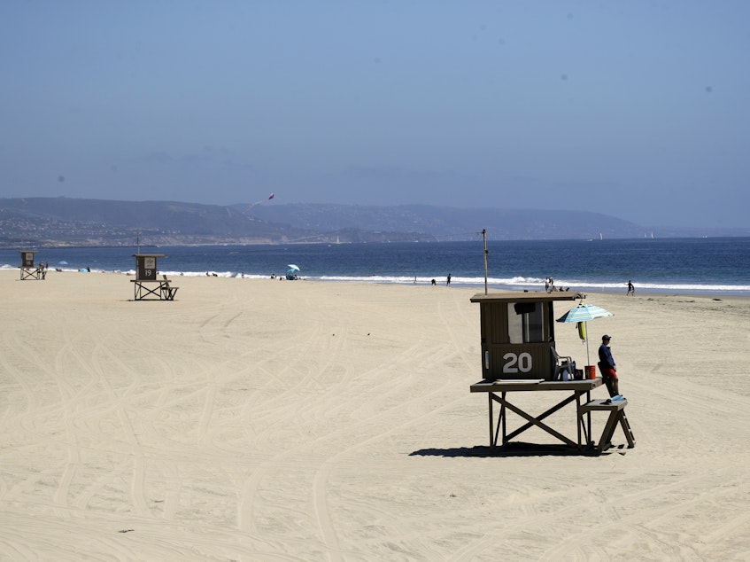 caption: In Newport Beach the beaches were practically empty this weekend. Last weekend, thousands gathered on Orange County beaches, prompting Calif. Gov. Newsom to implement a beach shutdown in Orange County.