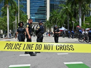 caption: Police officers are pictured outside the Wilkie D. Ferguson Jr. United States Courthouse before the arraignment of former President Donald Trump in Miami on Tuesday.