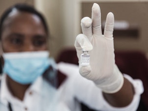 caption: A vile containing Pfizer vaccine to be administered is seen ahead of the launch of the VaxuMzansi National Vaccine Day Campaign in South Africa on Sept. 24, 2021.