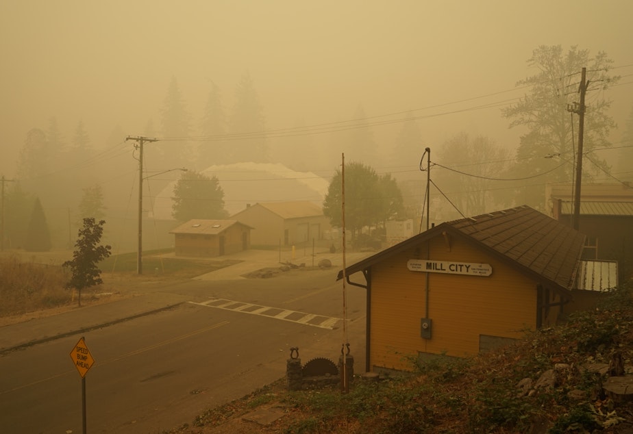 caption: Smoke blankets Mill City, Oregon, which was evacuated for days following the nearby Beachie Creek Fire.