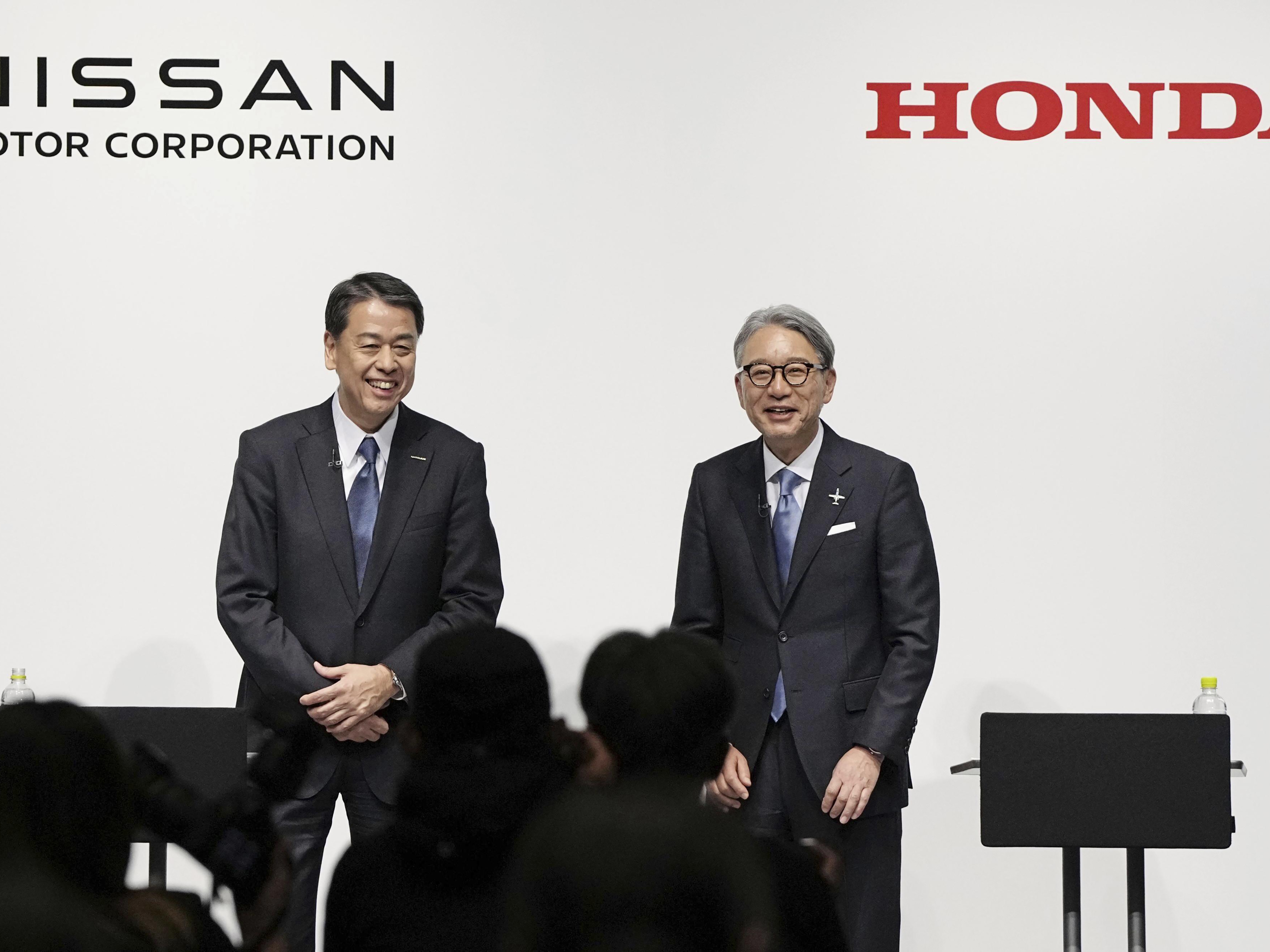 caption: Nissan Chief Executive Makoto Uchida, left, and Honda President Toshihiro Mibe attend a joint news conference in Tokyo, Friday, March 15, 2024.