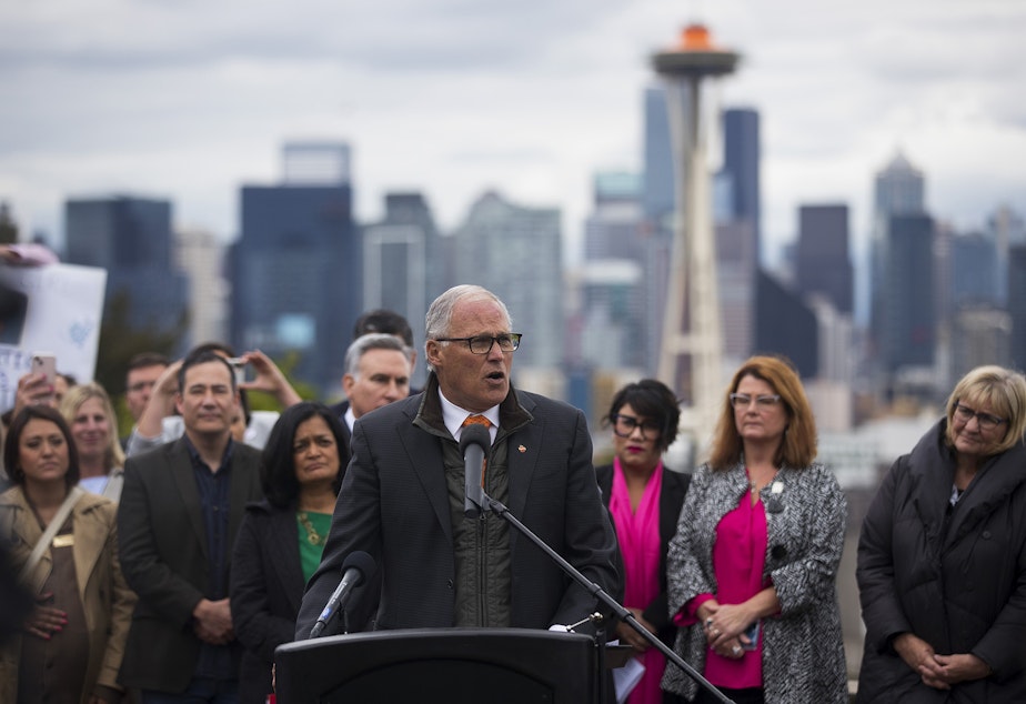 caption: Washington state governor Jay Inslee speaks to a crowd gathered for a pro-choice rally and press conference on Tuesday, May 3, 2022, at Kerry Park in Seattle. 
