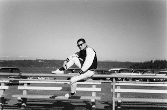 caption: Bruce Lee spent formative years in Seattle. He attended the University of Washington from 1961 to 1964, majoring in philosophy. Behind him is Lake Washington, the subject of many of his poems. 