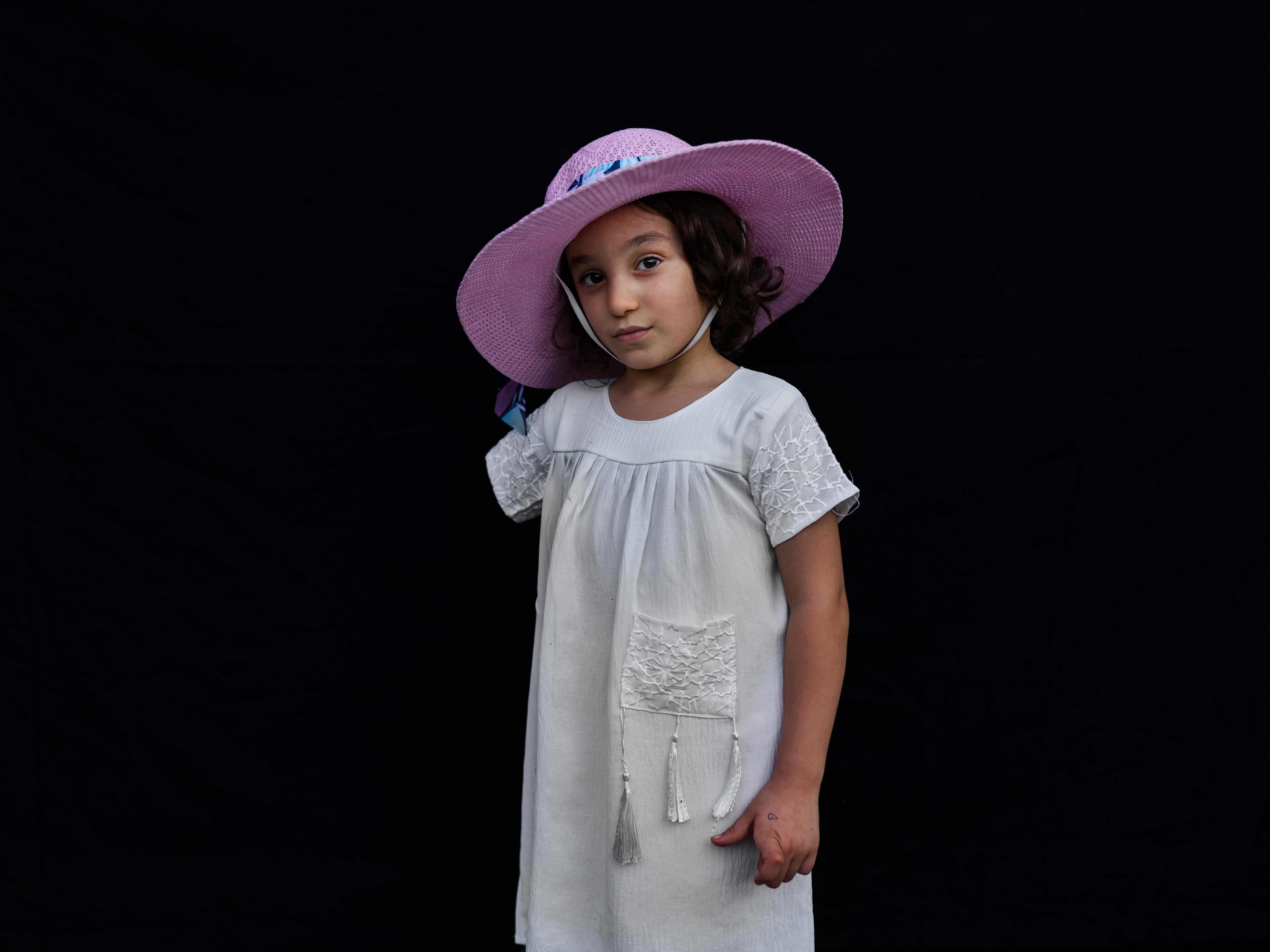 caption: Six-year-old Kenzi Madhoun from Gaza outside the American University of Beirut Medical Center. She arrived with her father, Adam Madhoun, to begin treatment after losing an arm as a result of an Israeli air strike on Oct. 21, 2023. She is among nearly 35 Palestinian children so far that the Ghassan Abu-Sittah Children's Fund has brought with their caretakers to Lebanon for medical and psychological support.