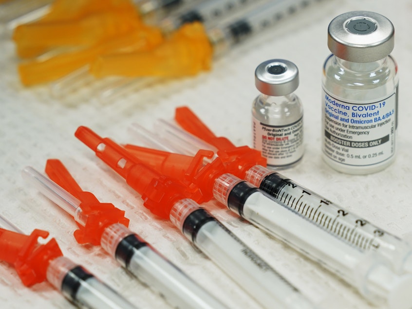 caption: Bivalent COVID-19 vaccines are readied for use at a clinic in Richmond, Va., Nov. 2022. Just 15% of eligible Americans have gotten the most recent booster shot, according to the CDC.