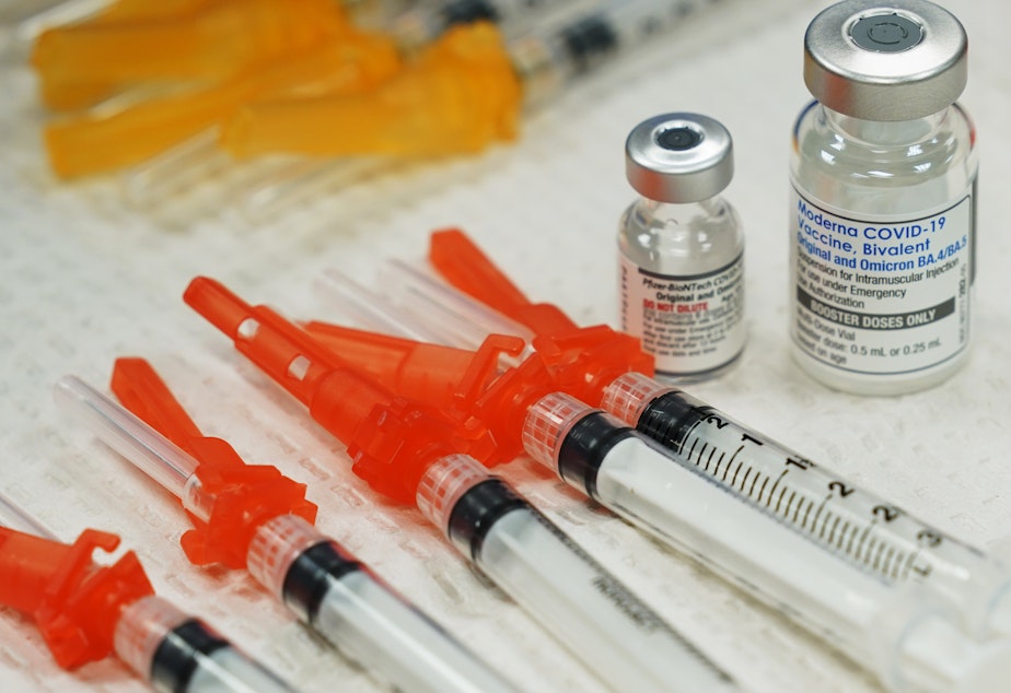 caption: Bivalent COVID-19 vaccines are readied for use at a clinic in Richmond, Va., Nov. 2022. Just 15% of eligible Americans have gotten the most recent booster shot, according to the CDC.