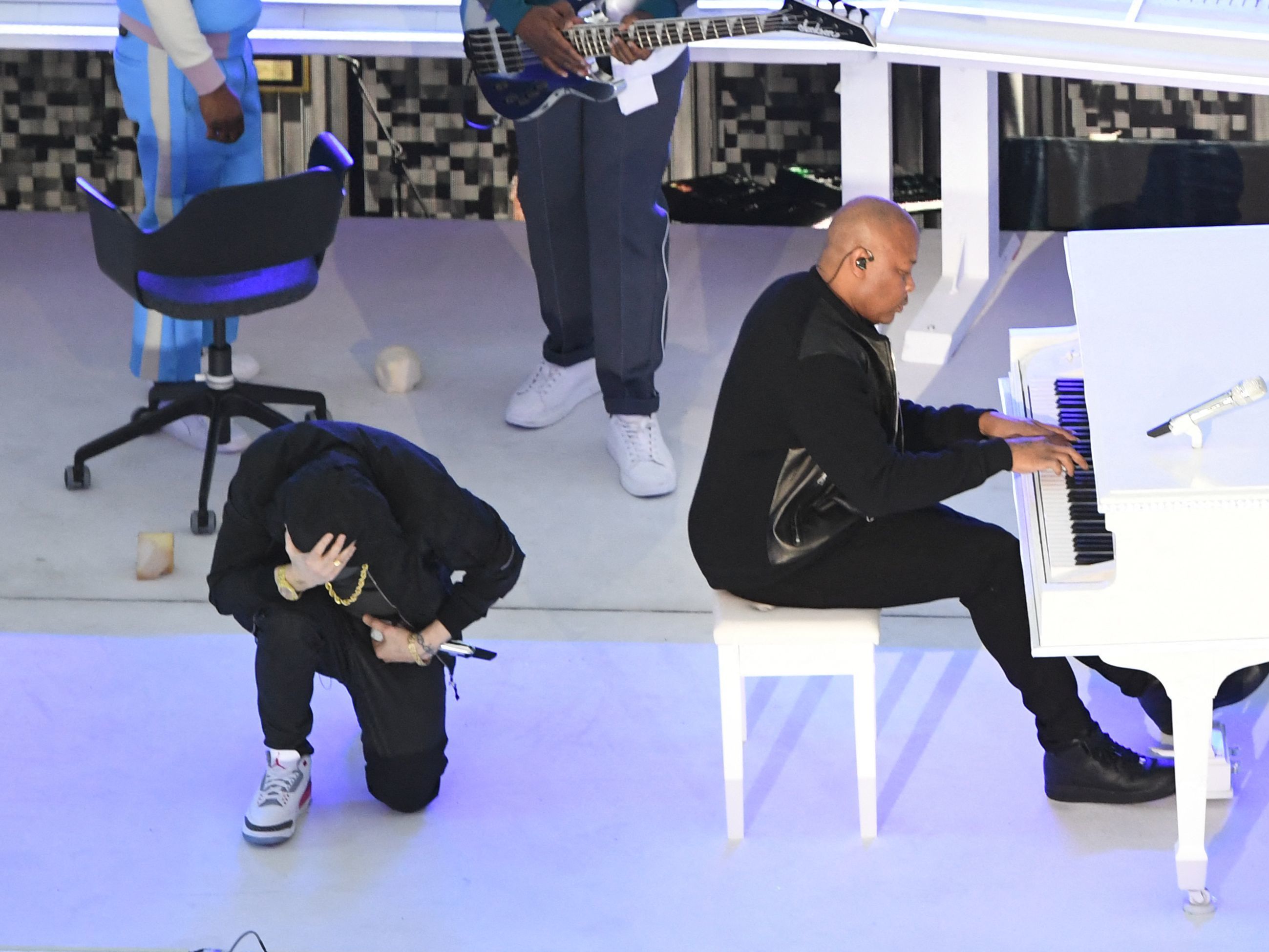 caption: Eminem took a knee as he performs during the Super Bowl halftime show.
