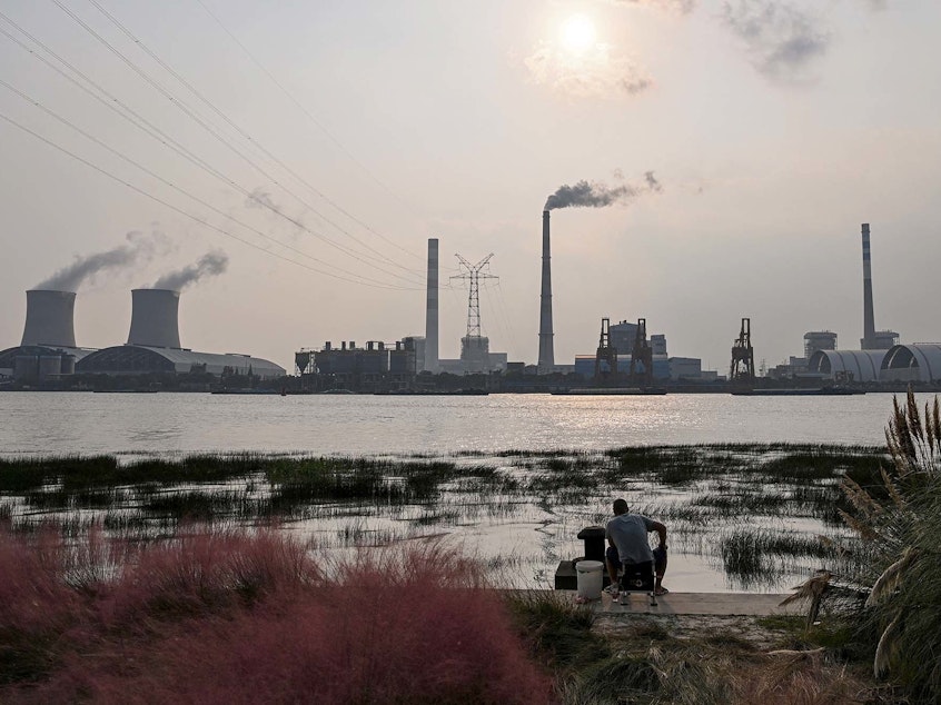 caption: Scientists warn the world needs to dramatically reduce fossil fuel use, but many countries still depend on coal power, like from the Wujing Coal-Electricity Power Station in Shanghai, China.