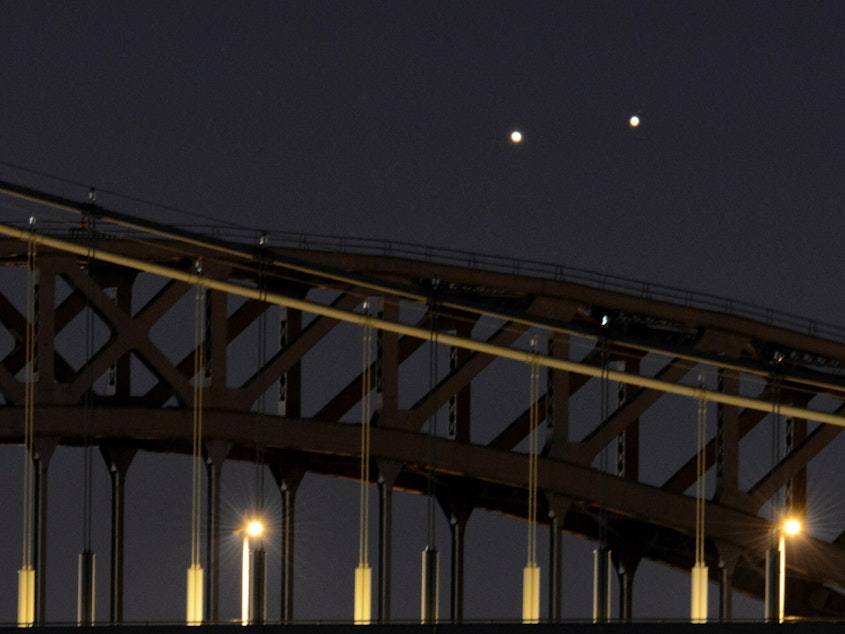 caption: Venus and Jupiter, in a rare conjunction, seem close even though they are 400 million miles apart.