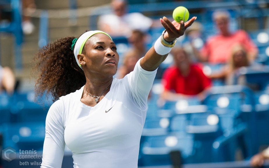 caption: Serena Williams gears up for a serve.