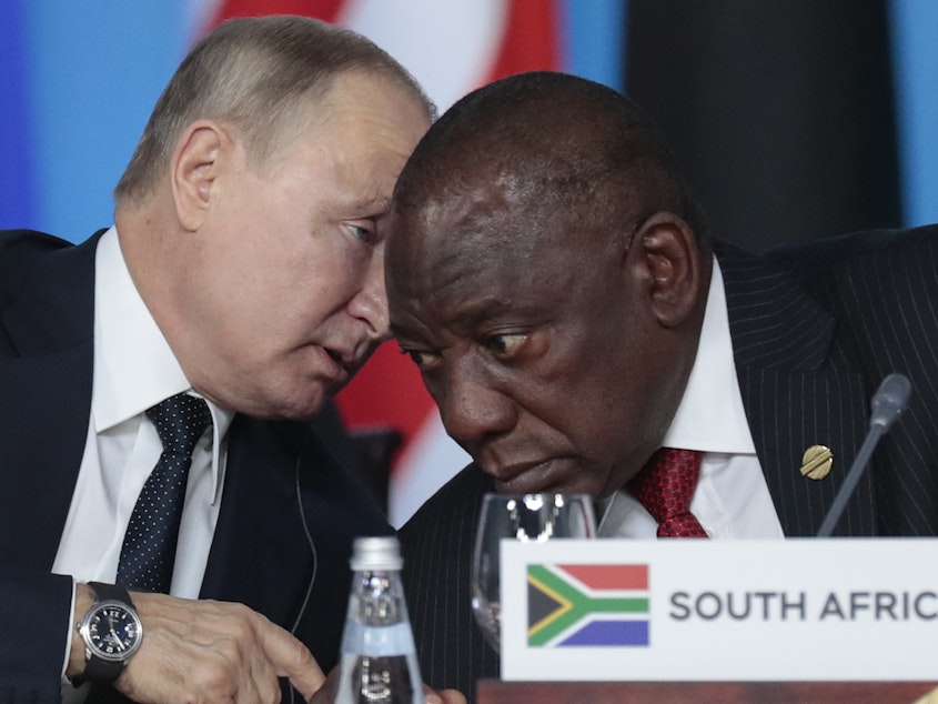 caption: Russian President Vladimir Putin (left) speaks to South African President Cyril Ramaphosa during a plenary session at the Russia-Africa summit in the Black Sea resort of Sochi, Russia, on Oct. 24, 2019.