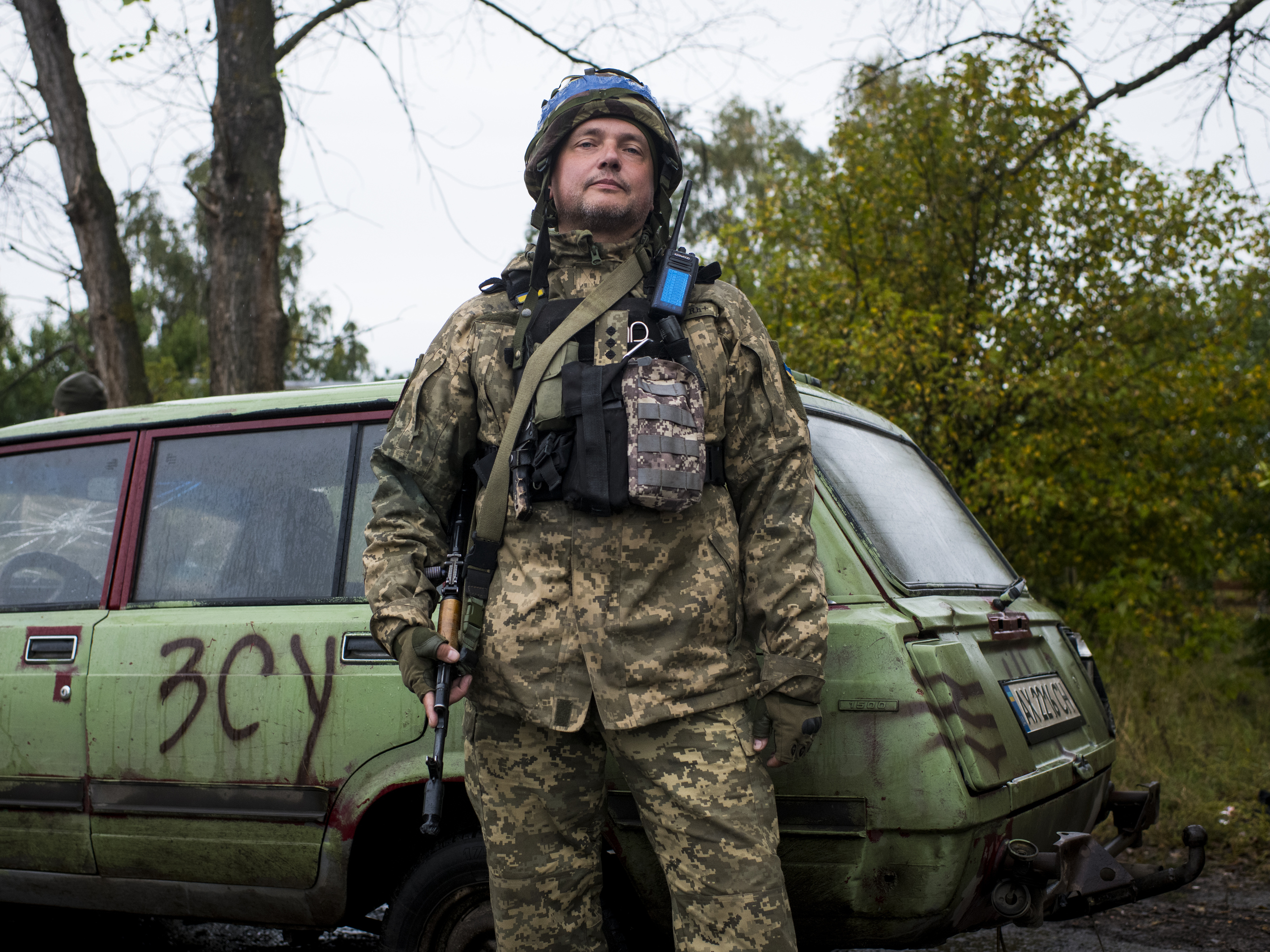 caption: A soldier who was formerly an IT entrepreneur and asked to be identified only by his call sign "Arun" manning a checkpoint in Borshchova, in northeastern Ukraine, on Friday. Ukrainian troops took back the area from Russian forces earlier this month.