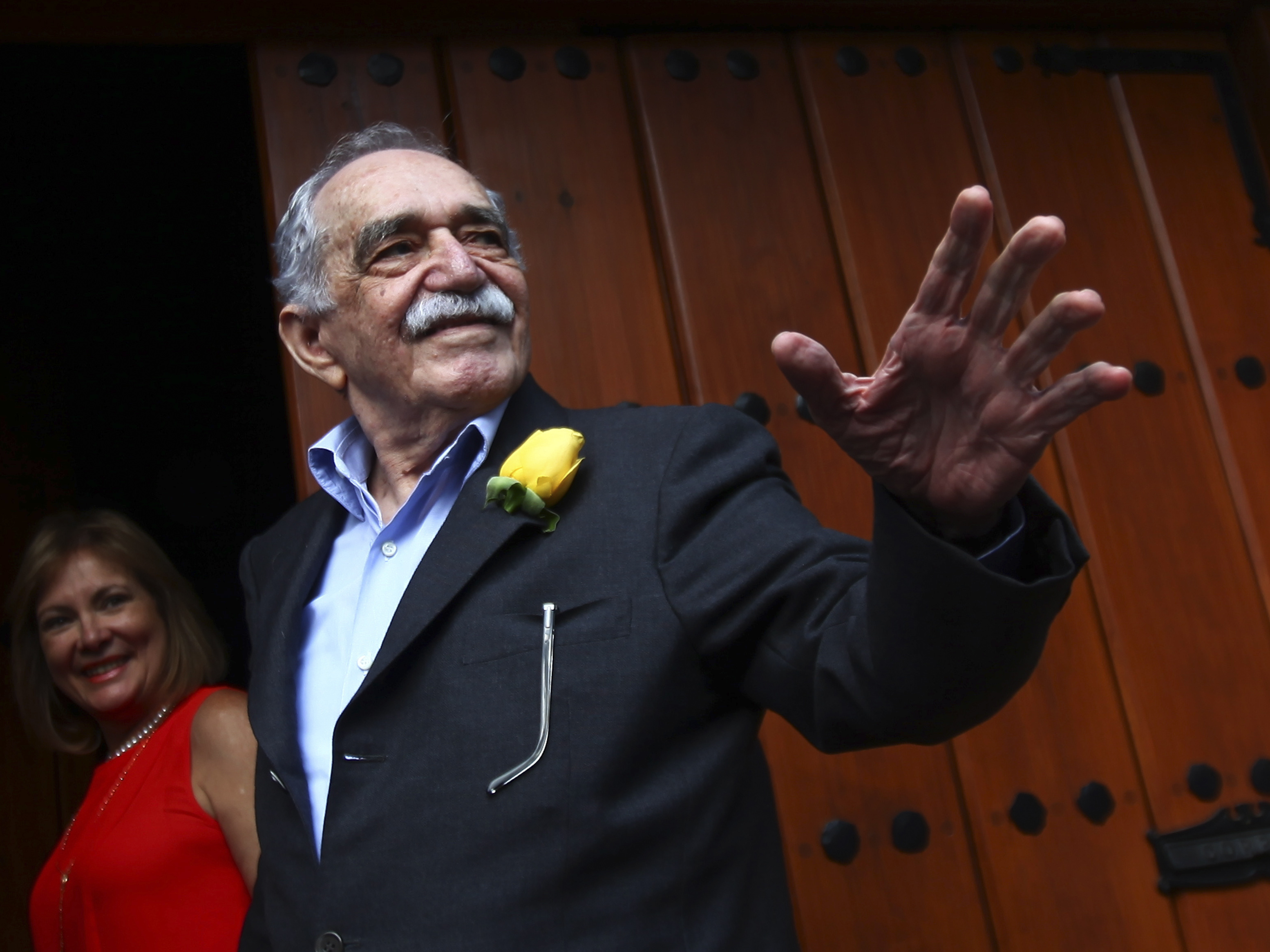 caption: Gabriel García Márquez greets journalists and neighbors on his birthday outside his house in Mexico City on March 6, 2014.