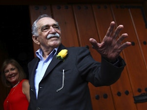 caption: Gabriel García Márquez greets journalists and neighbors on his birthday outside his house in Mexico City on March 6, 2014.