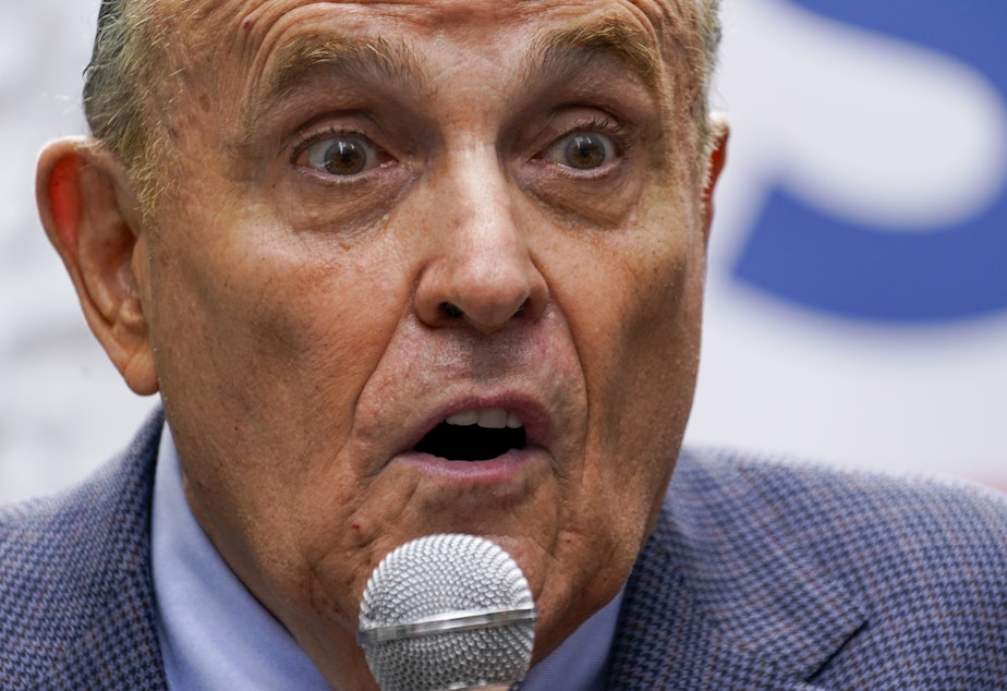 caption: Former New York City Mayor Rudy Giuliani speaks during a campaign event for Republican mayoral candidate Curtis Sliwa on June 21 in New York.