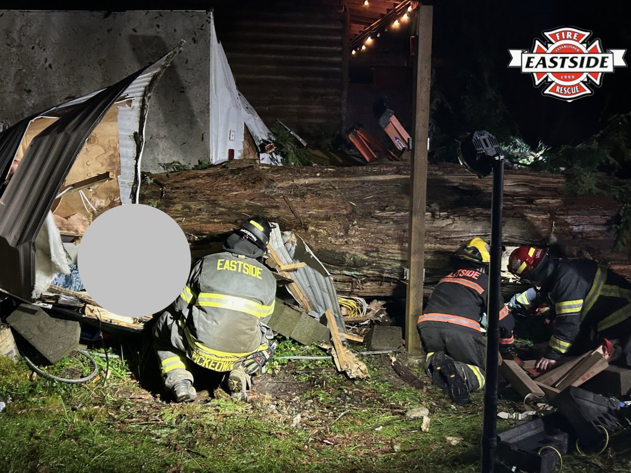caption: Eastside Fire and Rescue rescued someone trapped inside a camper after a tree had fallen on it during a strong wind storm March 11, 2026, in Carnation. The tree was 70-feet tall and nearly 5 foot in diameter.