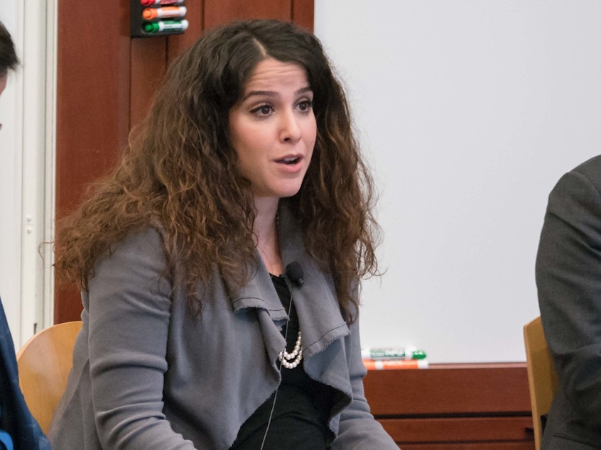 caption: Sahar Nowrouzzadeh (center), speaking at an event at the Harvard Kennedy School's Belfer Center in 2018. A report released by the State Department's Inspector General found that Nowrouzzadeh was improperly removed from her government post after articles attempting to smear her appeared on conservative websites.