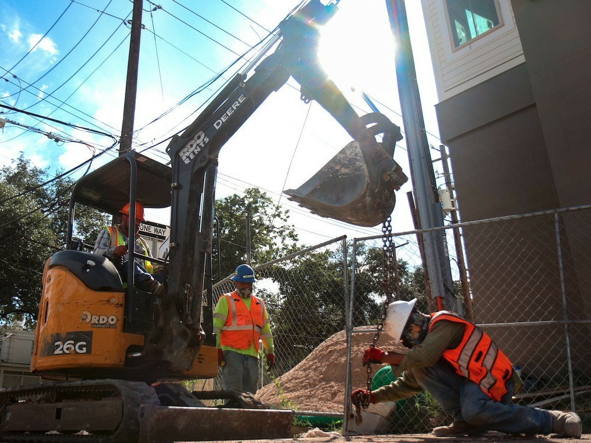 caption: Austin, Texas, construction workers dig on a hot day in August 2021. Last month, Gov. Greg Abbott signed a bill that overturns local ordinances in some Texas cities that mandate regular rest breaks for such workers.